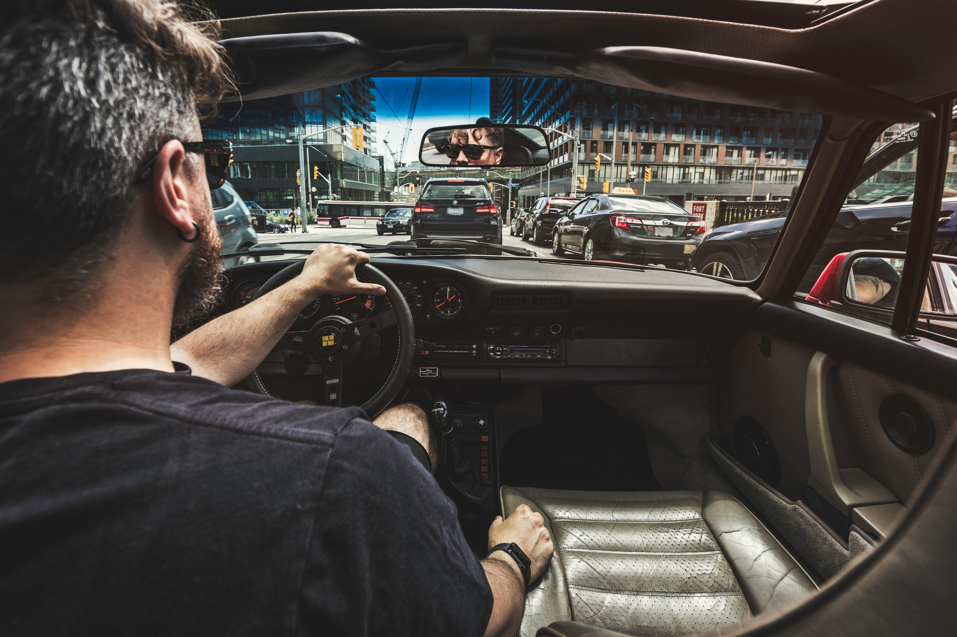 A man driving a car that is set with all his cool accessories and car hacks from car commodities 